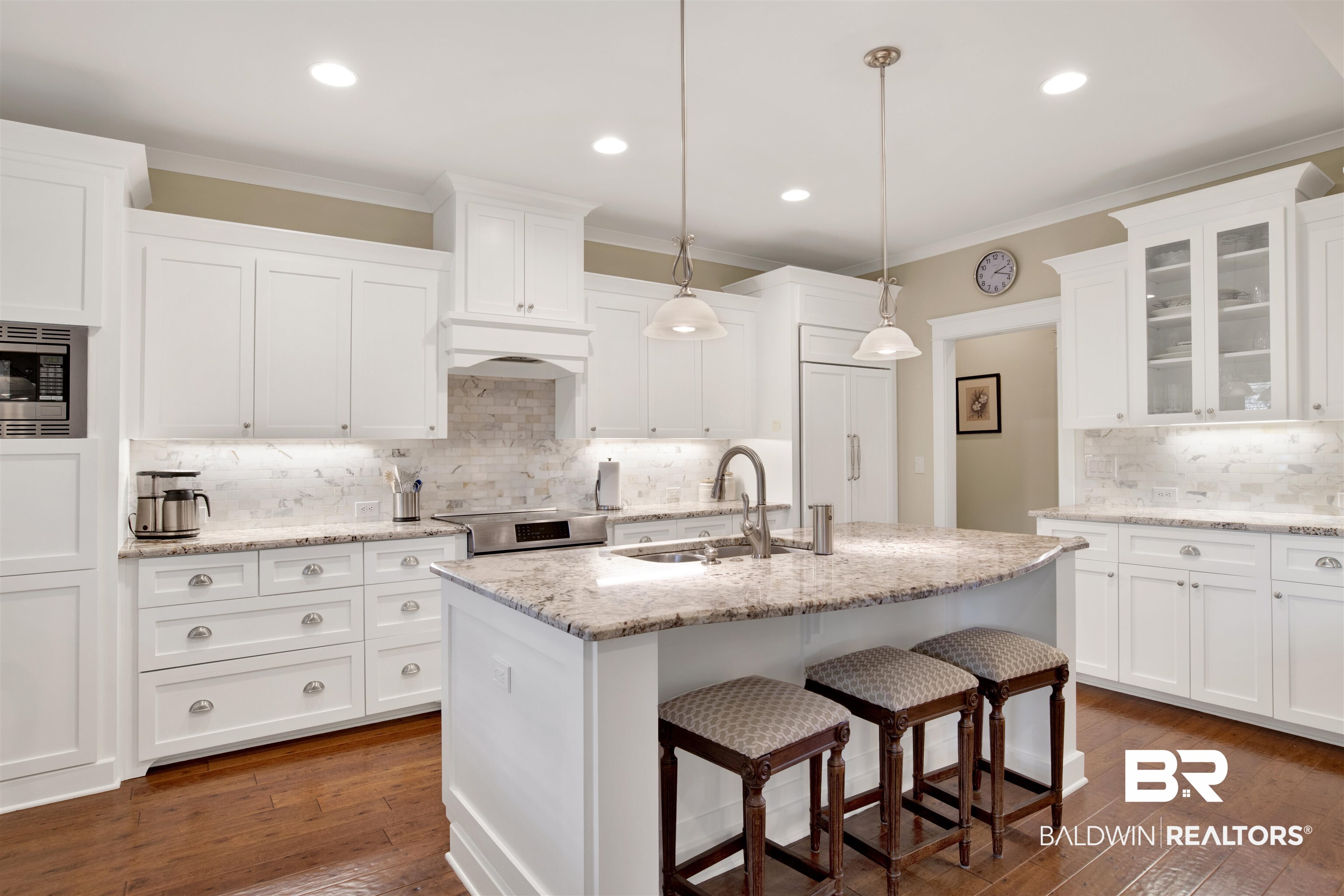 131 Sedgefield Avenue Fairhope, AL 36532 - Photo 15 of 50 Kitchen with tasteful backsplash, dark hardwood / wood-style flooring, white cabinets, sink, and stainless steel microwave
