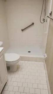a bathroom with a toilet and a shower