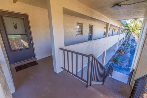 a view of a hallway with windows and stairs