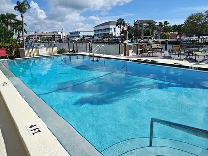 a view of a ocean with boats and trees in the background