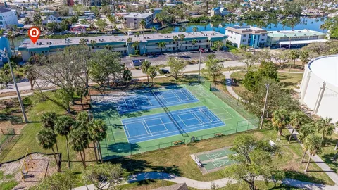 an aerial view of a house with a garden and lake view
