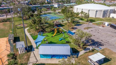 an aerial view of a house with a swimming pool yard and outdoor seating