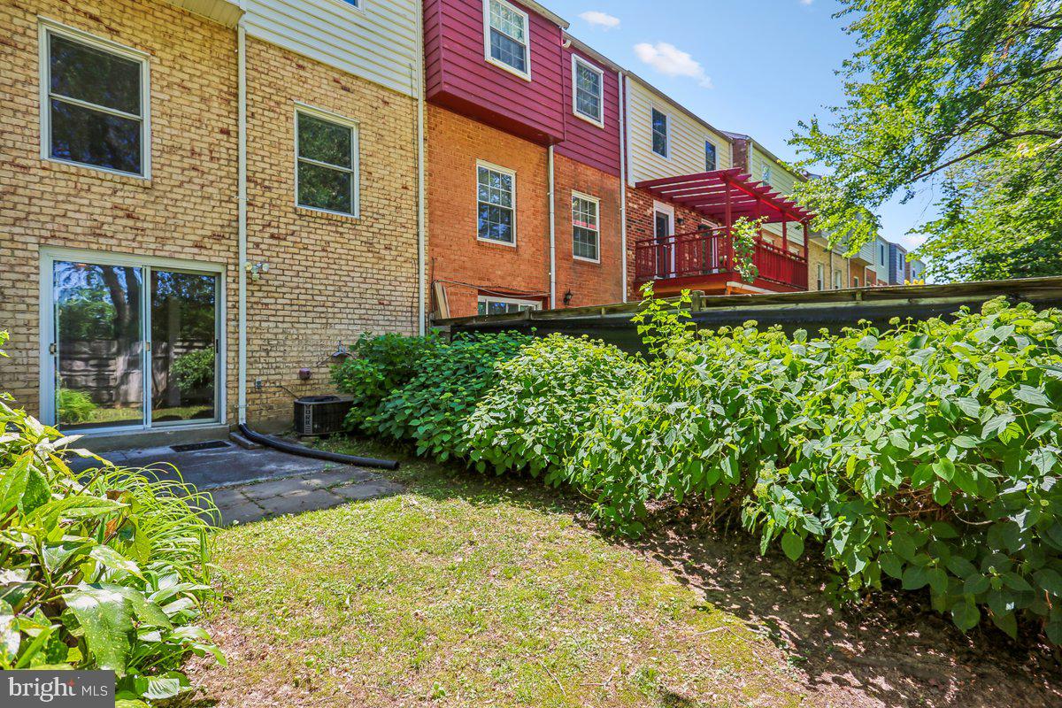 76 Timber Rock Road Gaithersburg, MD 20878 - Photo 3 of 51 a view of a brick house with a yard and potted plants