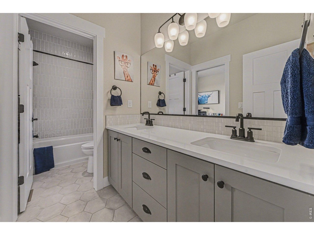 6309 2nd Street Greeley, CO 80634 - Photo 16 of 33 a bathroom with a sink a toilet and a large mirror