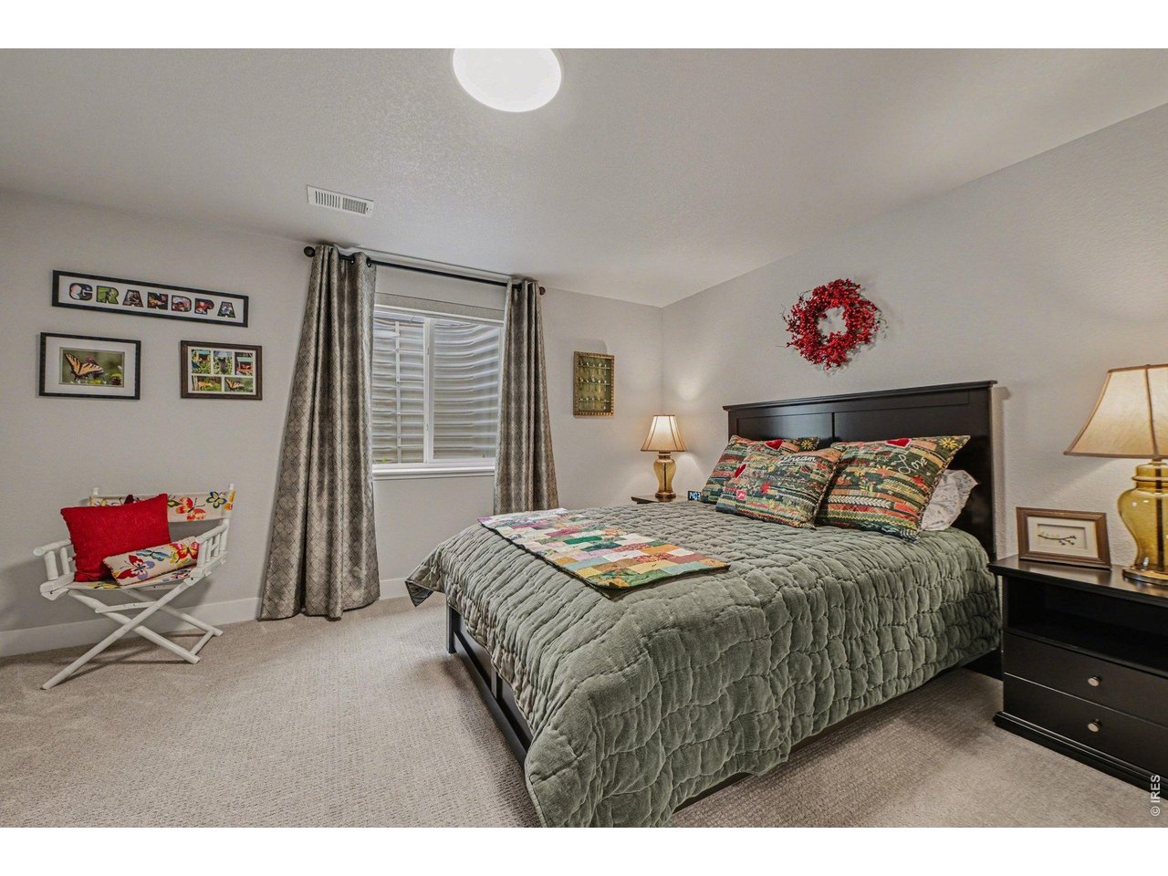 6309 2nd Street Greeley, CO 80634 - Photo 21 of 33 a bedroom with a bed and a chandelier