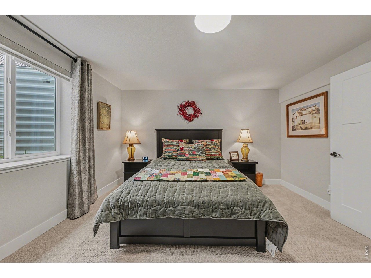 6309 2nd Street Greeley, CO 80634 - Photo 22 of 33 a bedroom with a bed and a painting on the wall