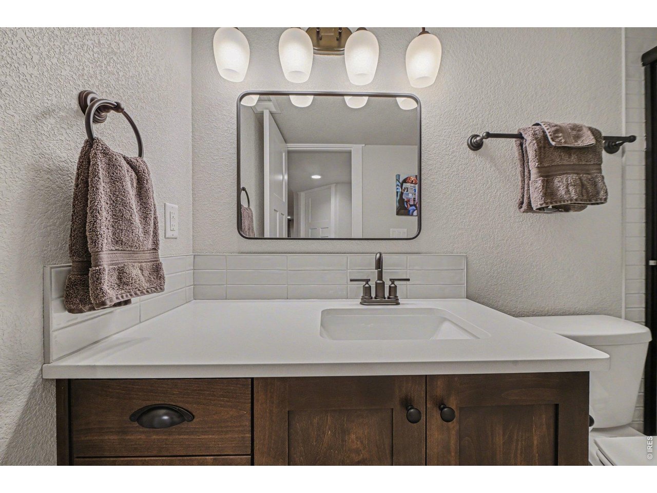 6309 2nd Street Greeley, CO 80634 - Photo 25 of 33 a bathroom with a sink vanity and a mirror