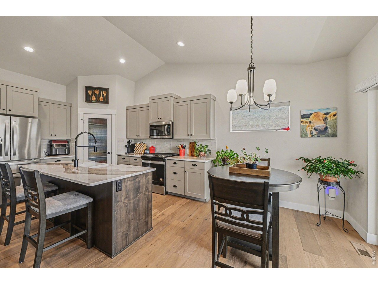 6309 2nd Street Greeley, CO 80634 - Photo 3 of 33 a kitchen with kitchen island stainless steel appliances a dining table and chairs