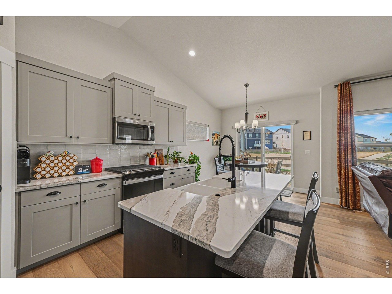 6309 2nd Street Greeley, CO 80634 - Photo 4 of 33 a kitchen with kitchen island a sink stove and wooden cabinets