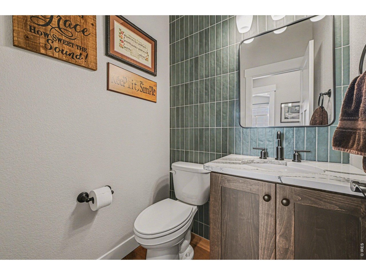 6309 2nd Street Greeley, CO 80634 - Photo 9 of 33 a bathroom with a granite countertop toilet sink and mirror