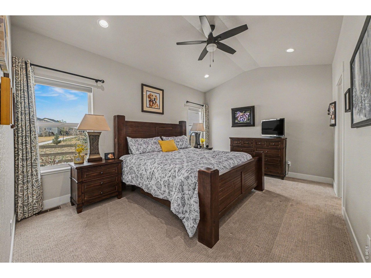 6309 2nd Street Greeley, CO 80634 - Photo 10 of 33 a spacious bedroom with a bed and a chandelier