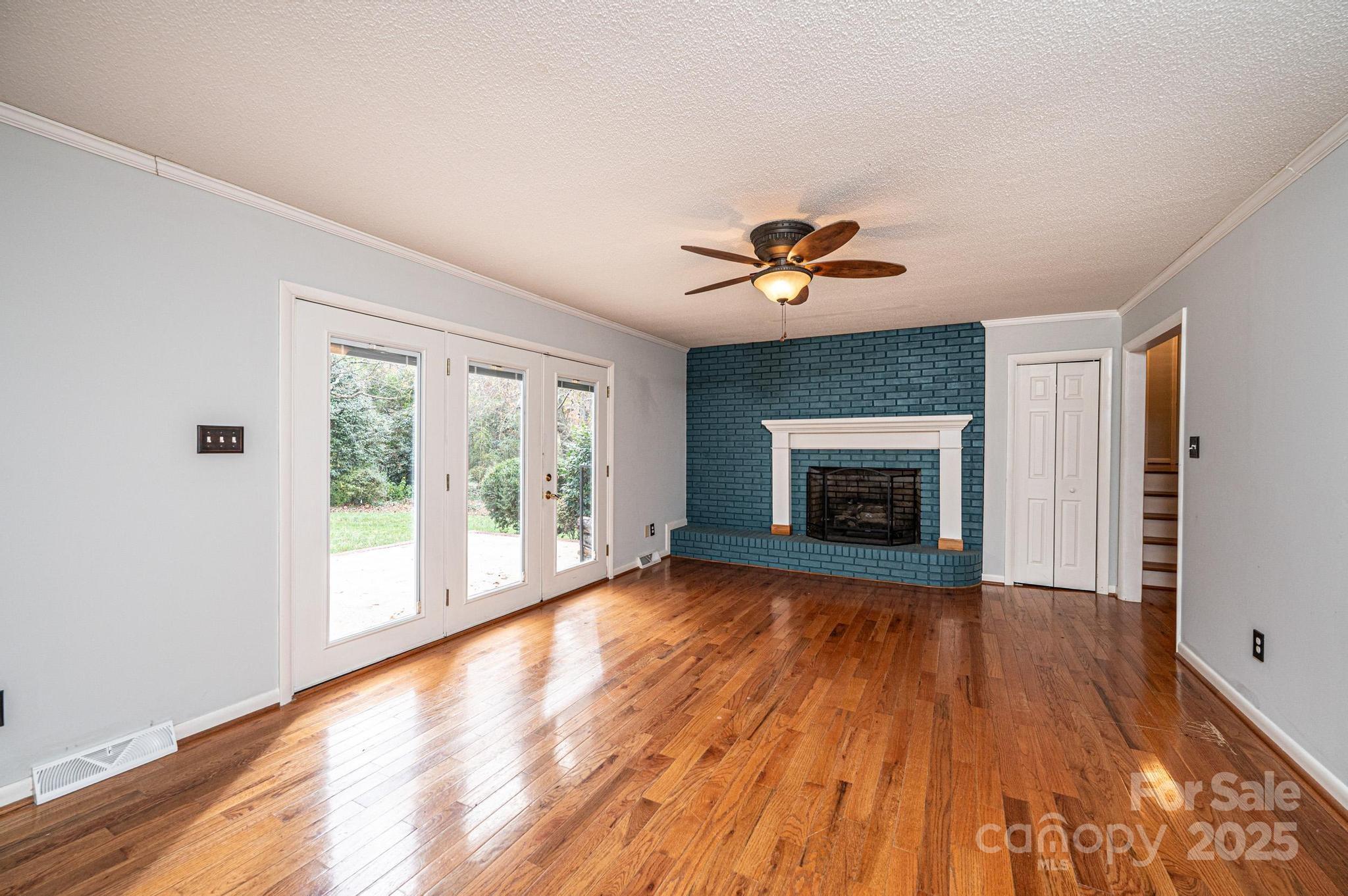 710 4th Avenue Northeast Conover, NC 28613 - Photo 11 of 33 wooden floor fireplace and windows in an empty room