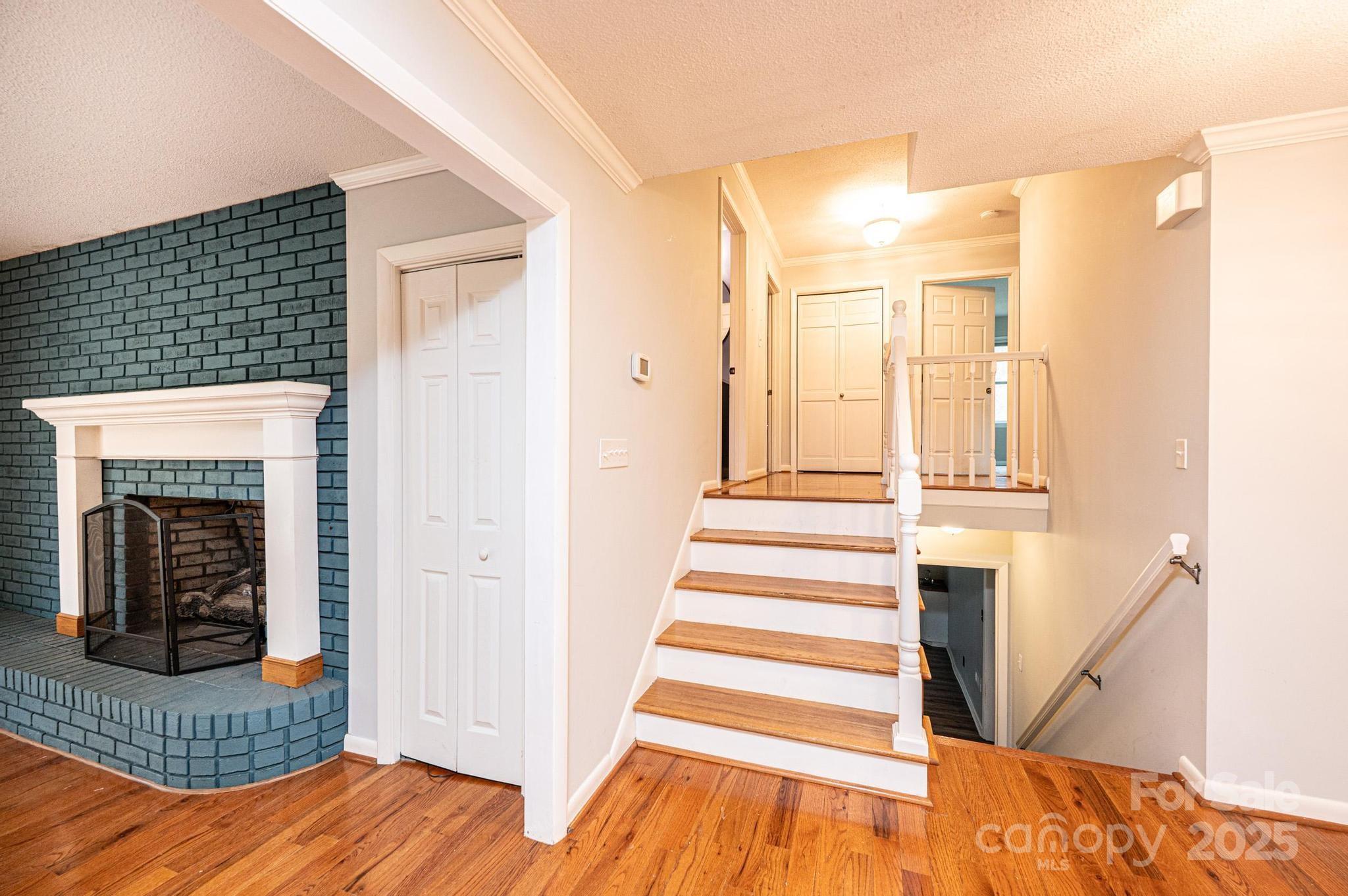 710 4th Avenue Northeast Conover, NC 28613 - Photo 12 of 33 a view of a bedroom with wooden floor and a fireplace