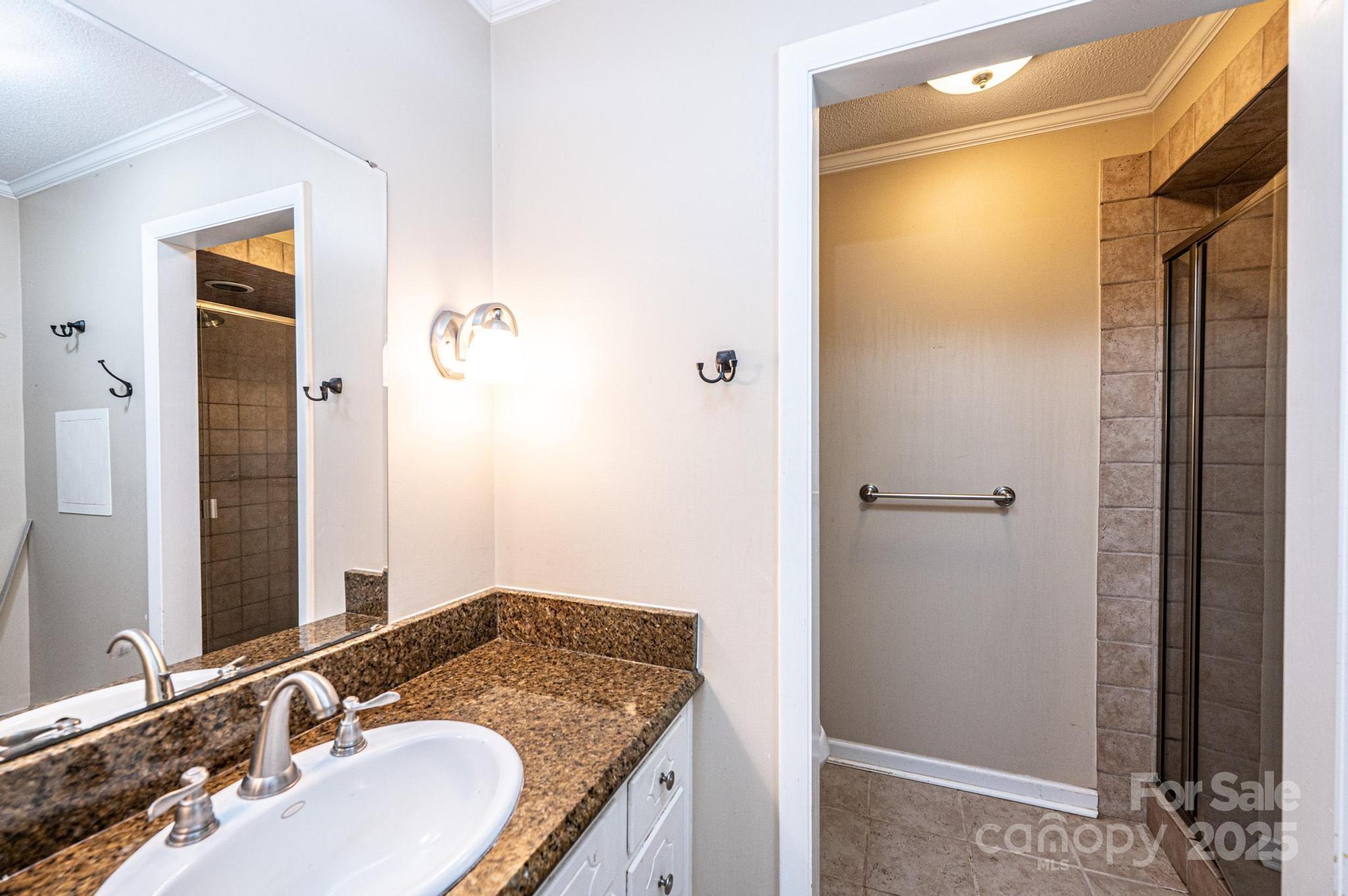 710 4th Avenue Northeast Conover, NC 28613 - Photo 19 of 33 a bathroom with a granite countertop sink and a mirror