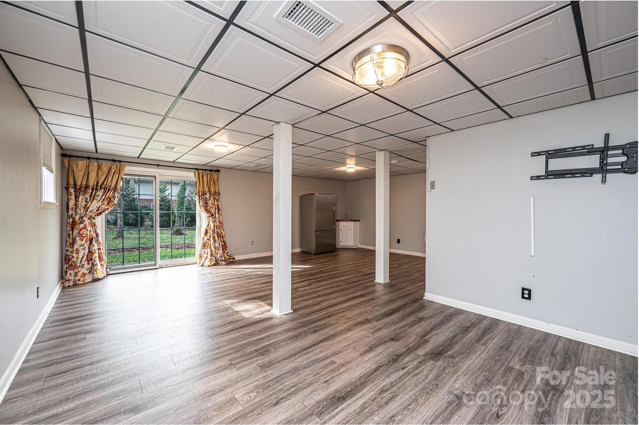 710 4th Avenue Northeast Conover, NC 28613 - Photo 21 of 33 a view of an empty room with wooden floor and a window