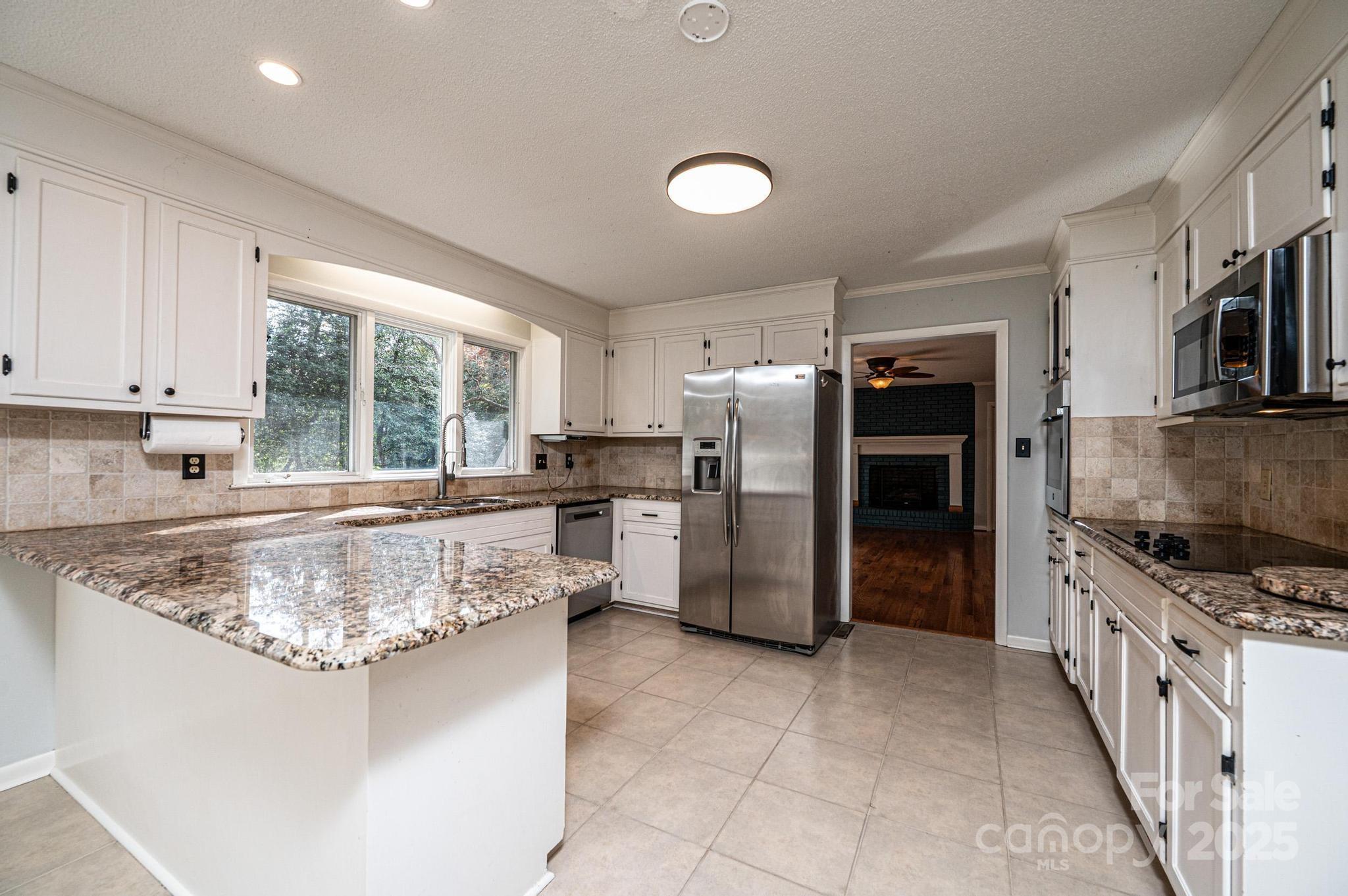 710 4th Avenue Northeast Conover, NC 28613 - Photo 8 of 33 a kitchen with refrigerator and cabinets
