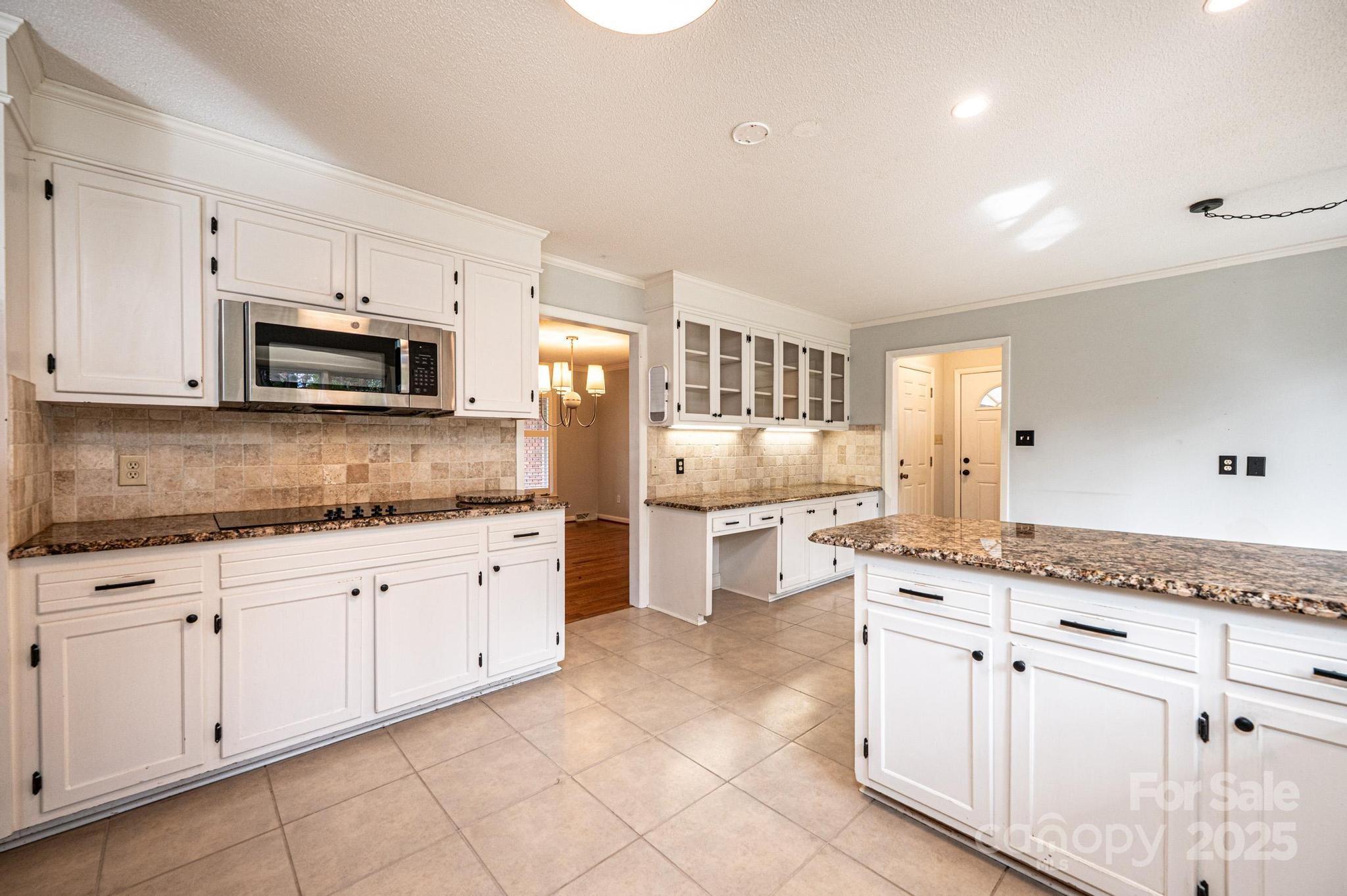 710 4th Avenue Northeast Conover, NC 28613 - Photo 9 of 33 a kitchen with granite countertop white cabinets white stainless steel appliances with a sink and dishwasher