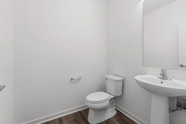 a bathroom with a sink a toilet and a mirror