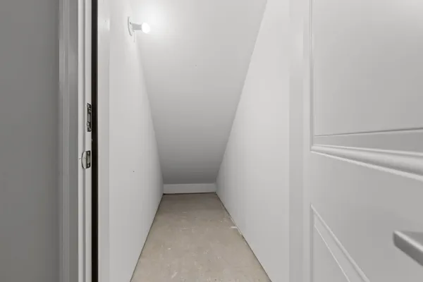 a front view of residential houses with cars parked