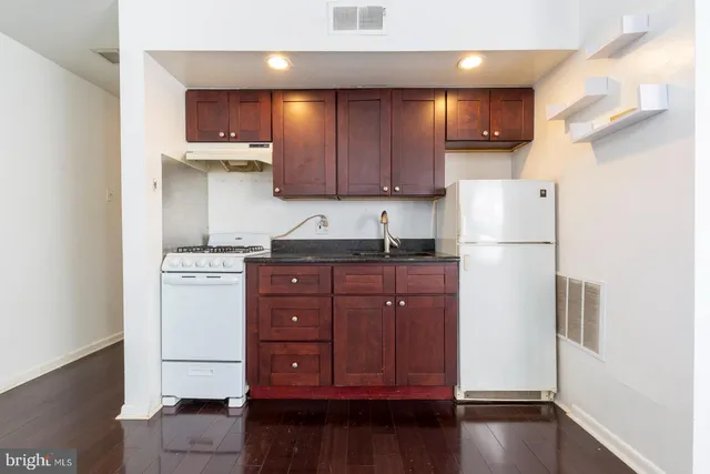 a kitchen with a refrigerator and a sink