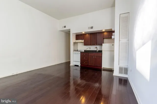 a view of kitchen with sink and wooden floor