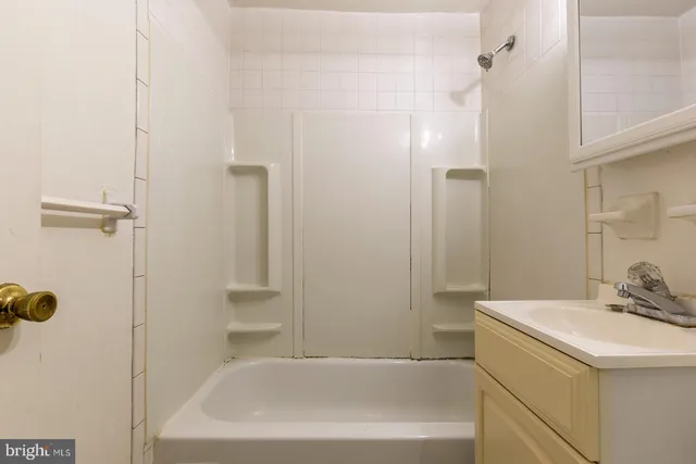 a bathroom with a bathtub and shower