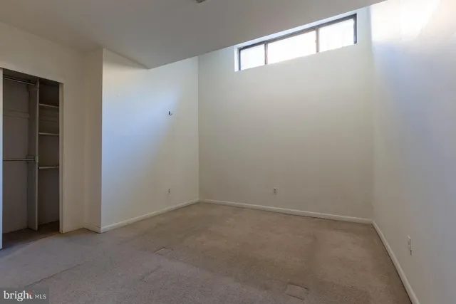 an empty room with a empty space and windows
