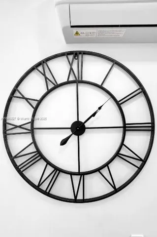 a kitchen with stainless steel appliances a sink a stove a refrigerator cabinets and wooden floor