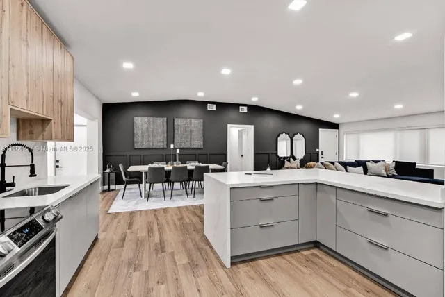 a large kitchen with a table and chairs