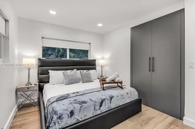 a bedroom with furniture and a lamp