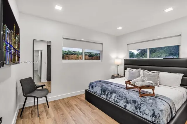 a bedroom with a bed and a night stand