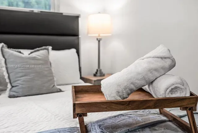 a bedroom with a bed and glass wall