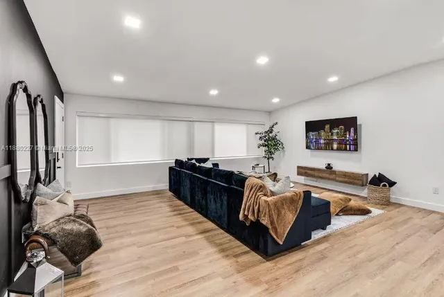 a living room with furniture and a potted plant