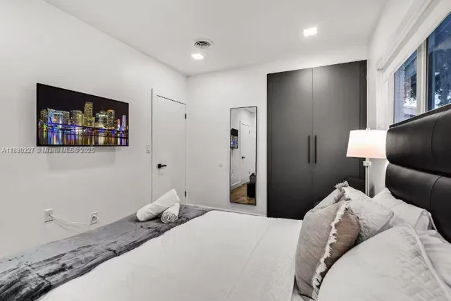 a bathroom with a double vanity sink toilet mirror and bathtub