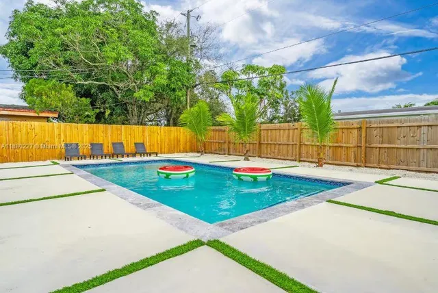 a view of swimming pool with a backyard