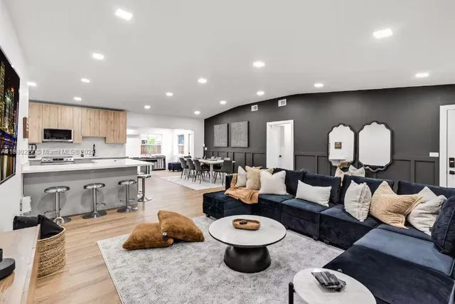 a room with furniture pool table and window