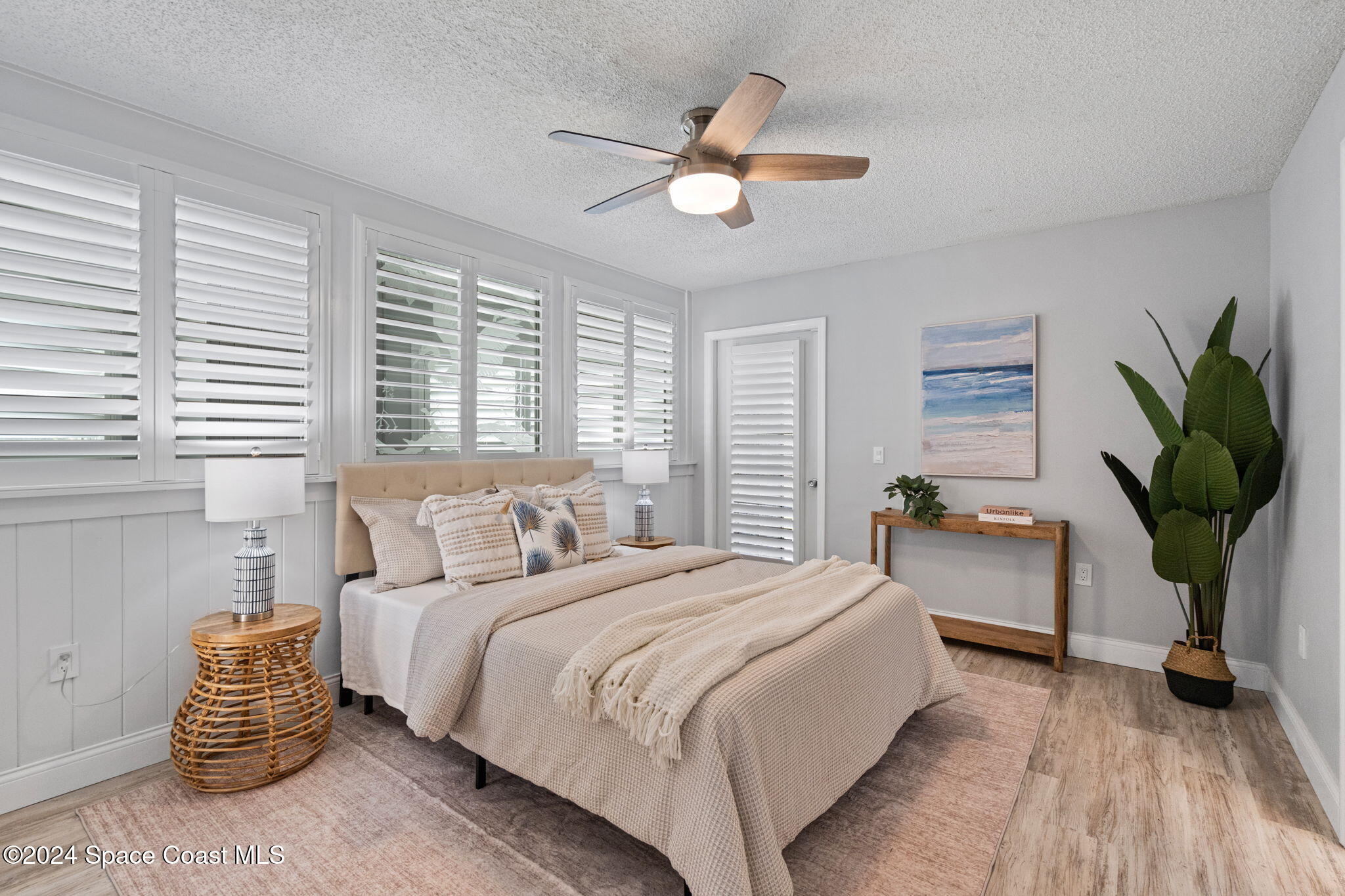 654 Cedar Side Circle Northeast Palm Bay, FL 32905 - Photo 21 of 35 a bedroom with a bed and a chandelier