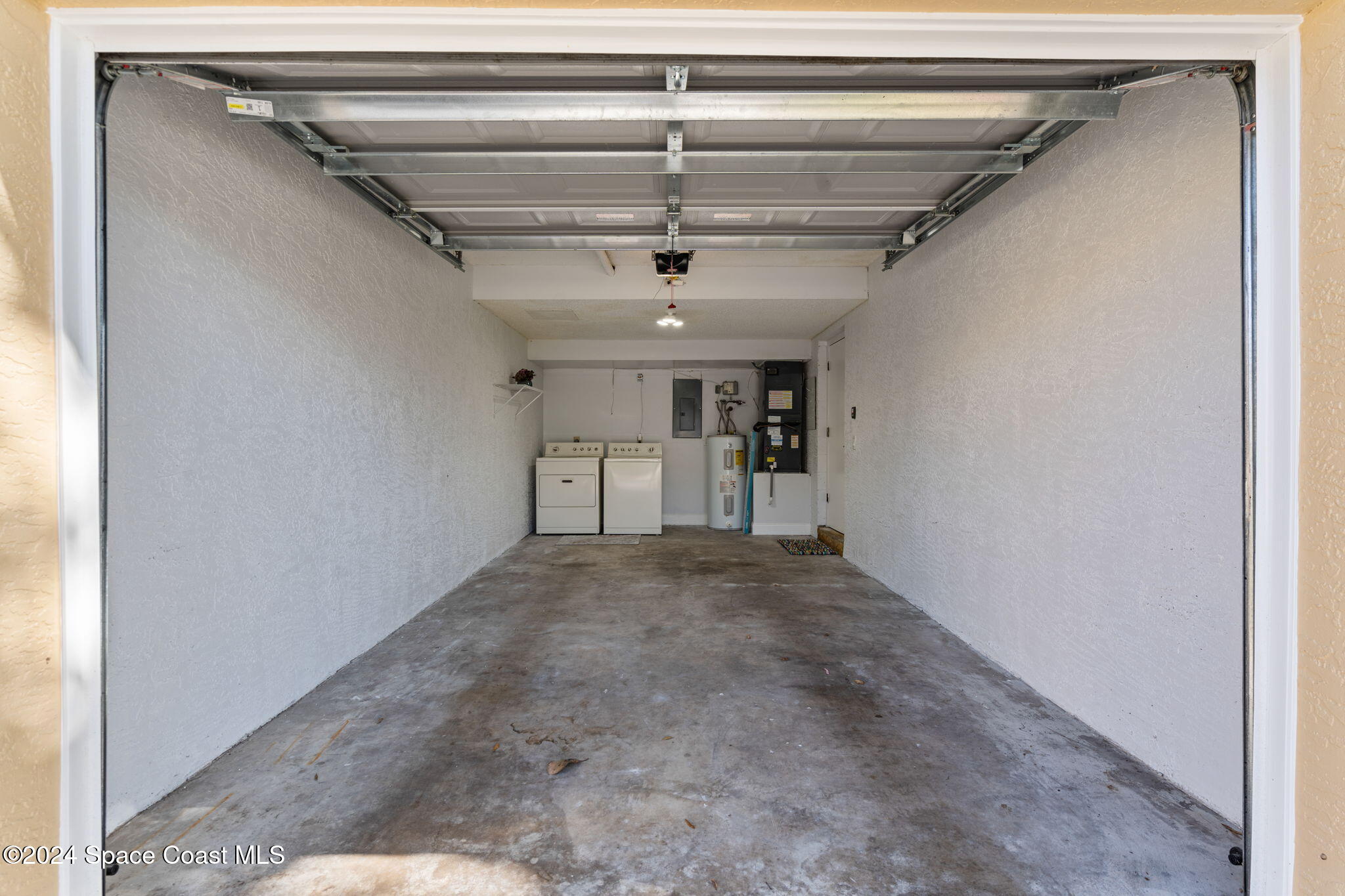 654 Cedar Side Circle Northeast Palm Bay, FL 32905 - Photo 28 of 35 a view of a hallway with wooden floors