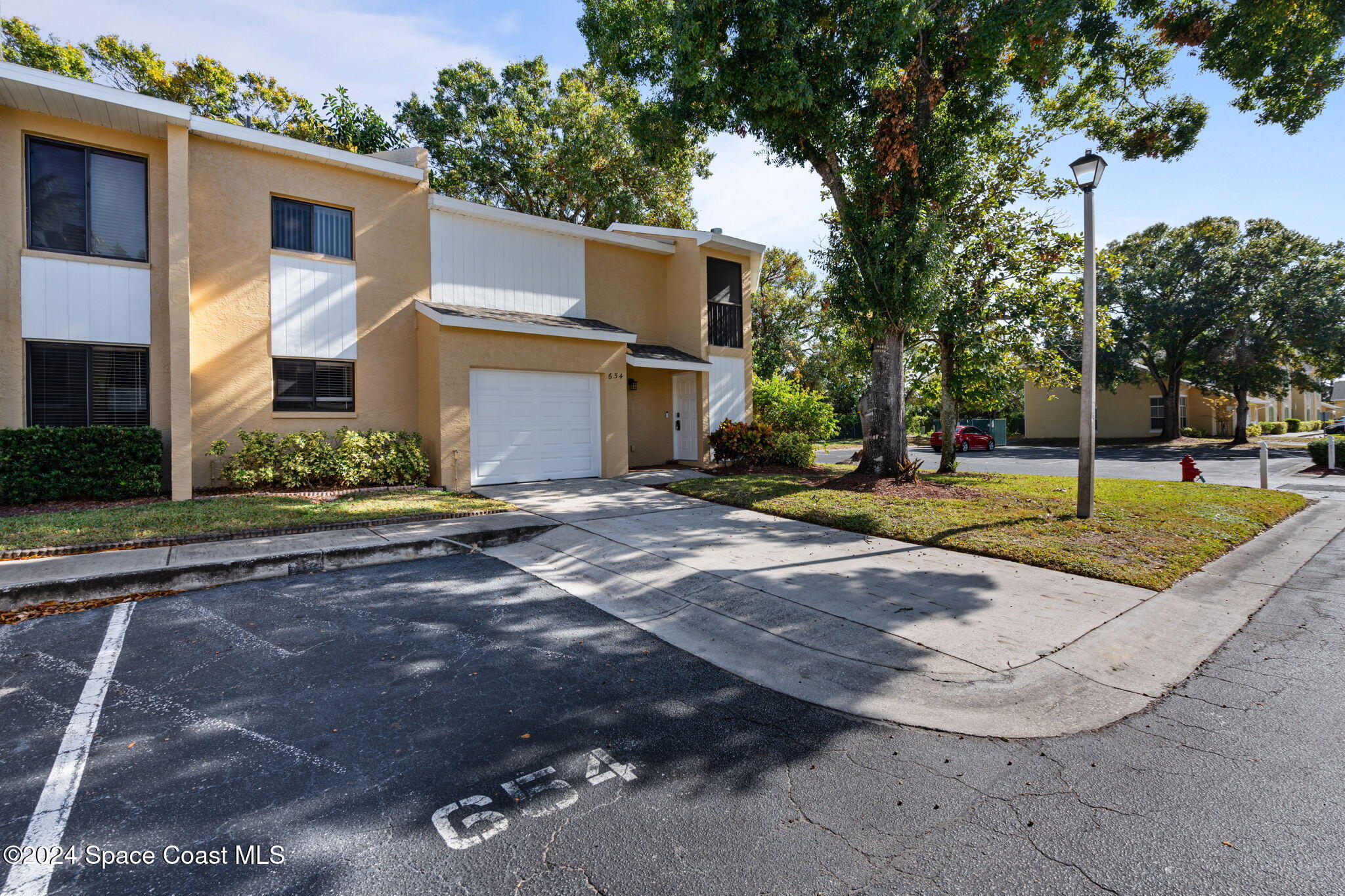 654 Cedar Side Circle Northeast Palm Bay, FL 32905 - Photo 3 of 35 a front view of a house with a yard