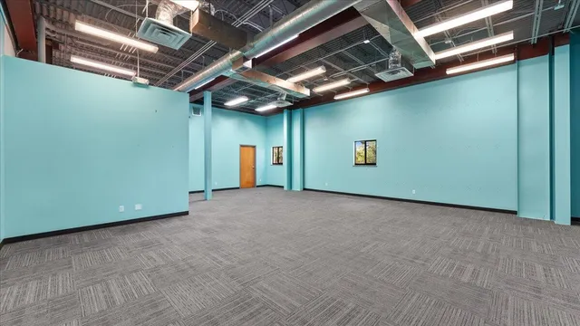 a view of kitchen with stainless steel appliances cabinets and a window