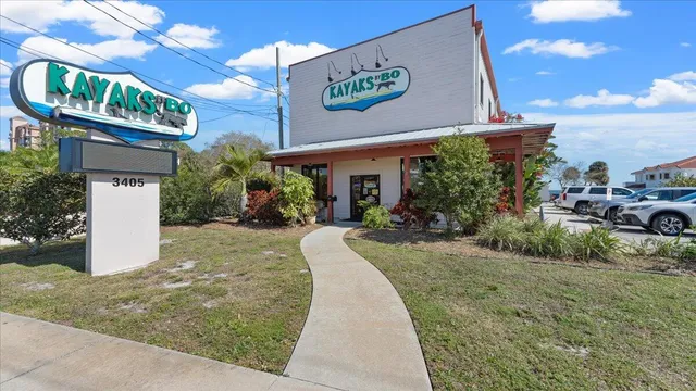 a view of a street with potted plants