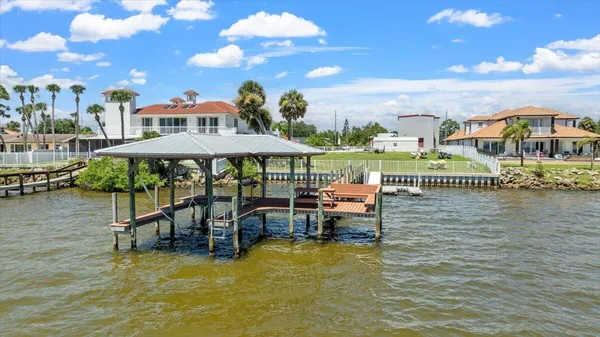 a swimming pool with outdoor seating and yard in back