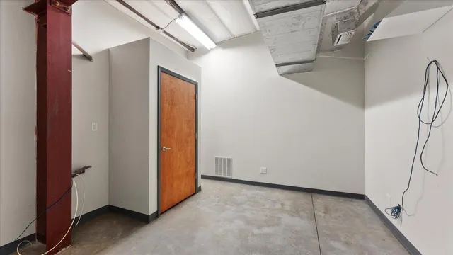 a view of a hallway with wooden floor and entryway