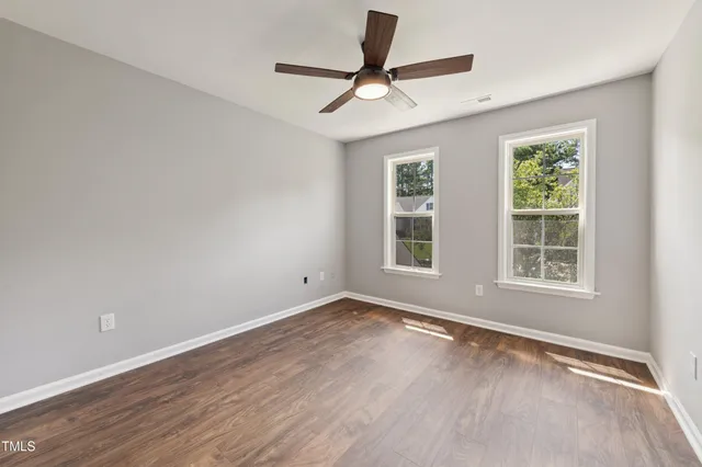 wooden floor in an empty room with a window