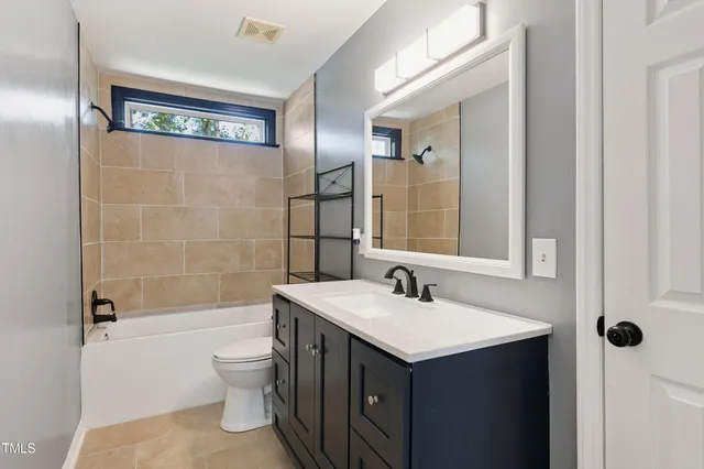 a view of a livingroom with a ceiling fan and window