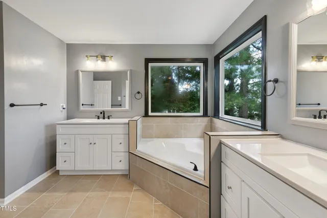 a white toilet sitting next to a white cabinet