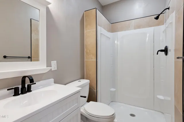 a bathroom with a sink a bathtub and next to a window