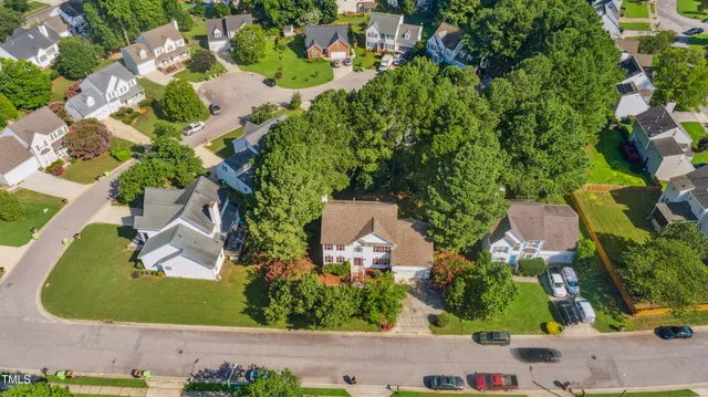 an aerial view of a house with a yard and garden