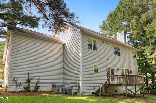 an aerial view of a house with a yard and lake view
