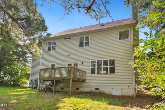 a view of a white house with a yard and sitting area